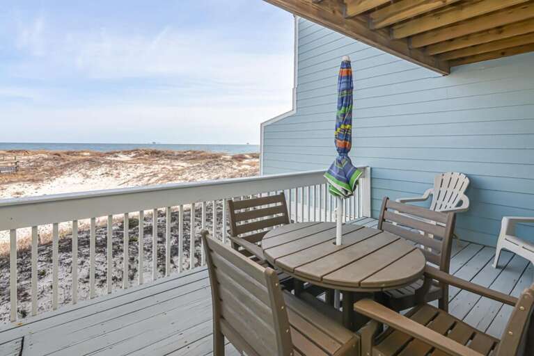 Balcony Beside Beach With Breezy Blue Backdrop, Table And Chairs
