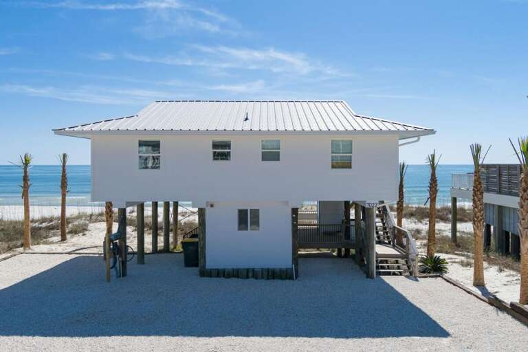 Beach-building Beneath Blue Sky, Sand Surrounds Structure