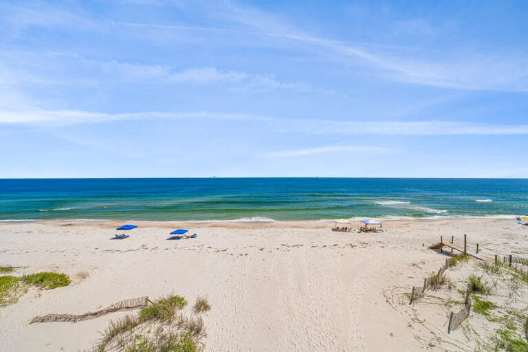 Beach Beauty: Bright Blue Water Beyond Bare Sandy Shore
