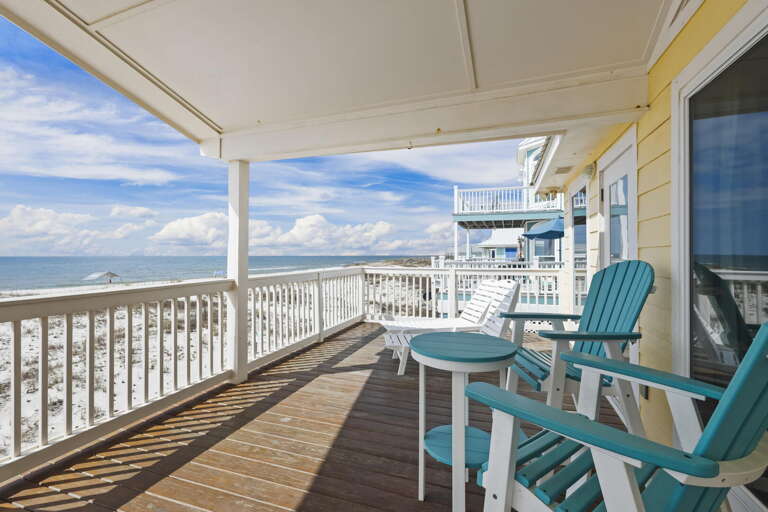 Seaside Vacation Rental Balcony With Beach Views And Blue Chairs