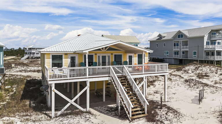 Beachside Building On Stilts, Sandy Surroundings, Sunny Skies