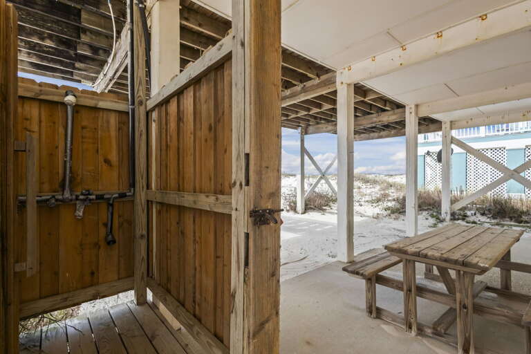 Beachfront Boardwalk Beneath Beams By Vacation Rental, Viewing Vast Sands And Serene Sea