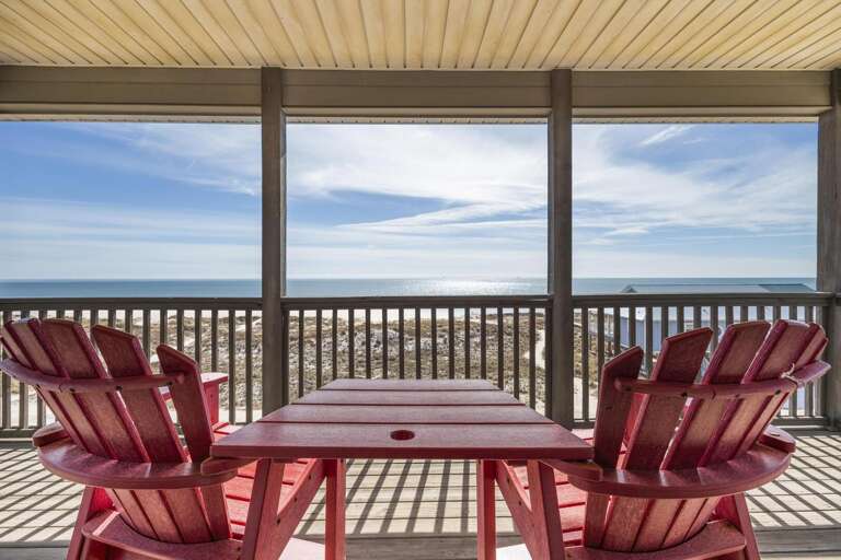 Seaside Scene Through Glass: Pristine Panorama Paired With Two Red Chairs On Deck