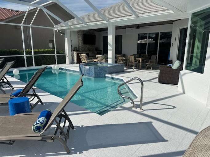 Poolside Patio With Loungers Under Sunny Sky