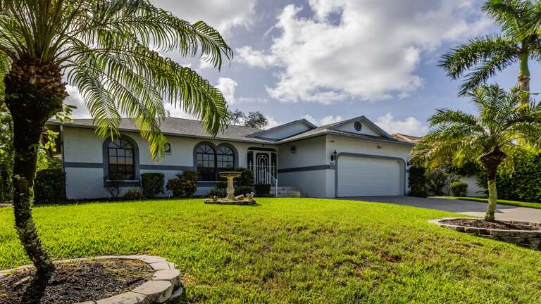 Suburban Single-story House With Palm Tree And Lawn Suburban Single-story House With Palm Tree And Lawn