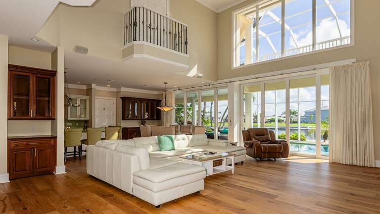 Spacious Living Room Interior With Vaulted Ceiling And Pool View