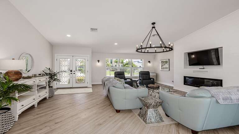Light-filled Living Space In A Vacation Rental, Featuring Soft Sofas And Sleek Surfaces