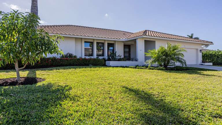 Sun-kissed Single-story Vacation Rental Flanked By Fresh Foliage