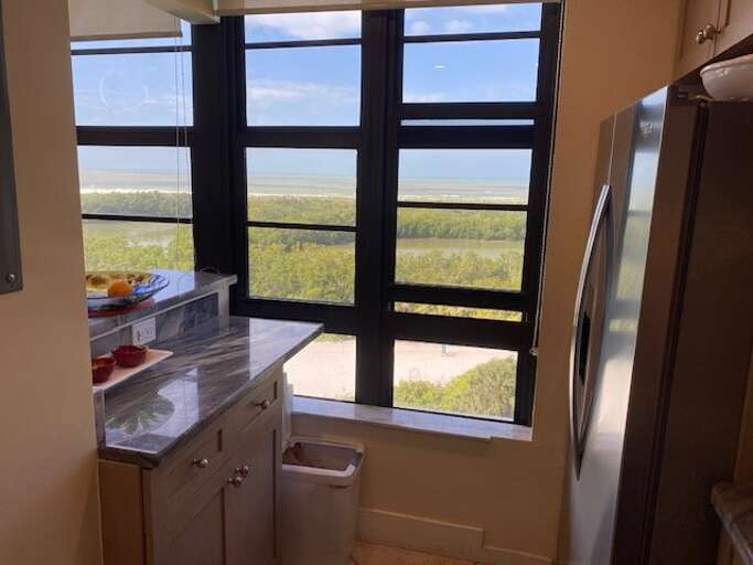 Kitchen Area With A View Of A Landscape Through A Window